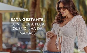 modelo com bata branca e abertura na barriga com escrito bata gestante conheca a peca queridinha das mamaes